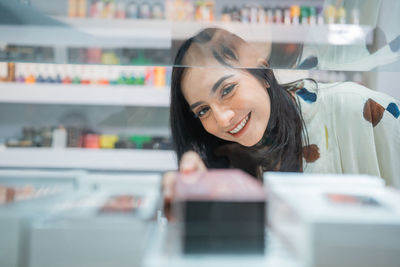 Portrait of young woman working at table