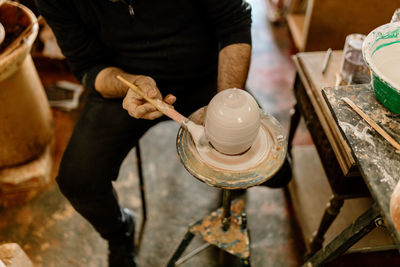 Midsection of man working at workshop