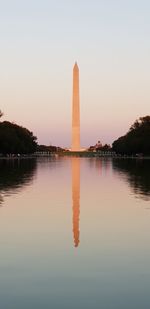 Reflection of building in lake at sunset