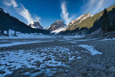 Scenic view of snowcapped mountains against sky