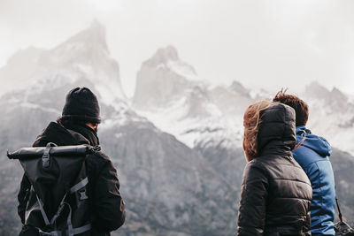 Rear view of people on mountain during winter