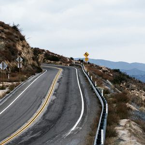 High angle view of road amidst trees against sky