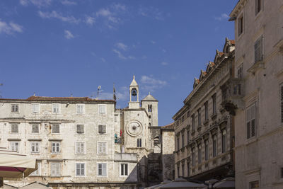 Low angle view of buildings against sky in city