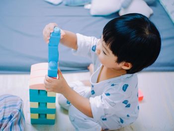 Close-up of boy playing with hands