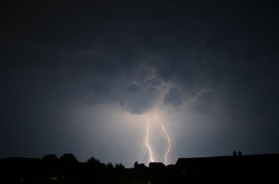 Low angle view of illuminated building against sky