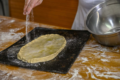 Cropped hand preparing food