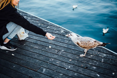 Woman on pier at sea