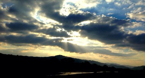 Scenic view of mountains against cloudy sky