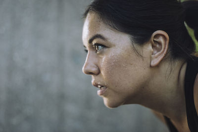 Face of determined woman doing work out