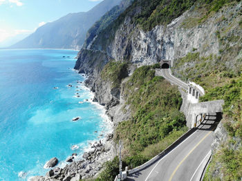 Panoramic shot of road by sea against sky