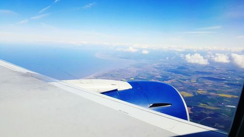 Aerial view of airplane wing over landscape