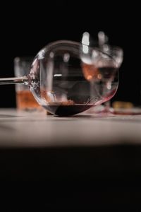 Close-up of drinking glass on table against black background