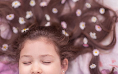 Close-up portrait of cute girl with flowers