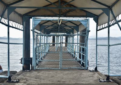 Pier over sea against sky