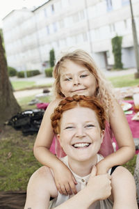 Portrait of smiling mother with daughter