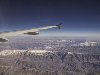 Aerial view of airplane flying over landscape