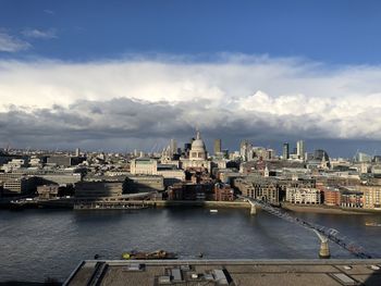 High angle view of river by buildings against sky