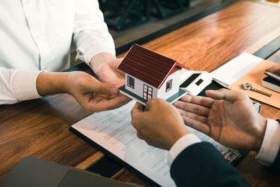 High angle view of man holding hands on table