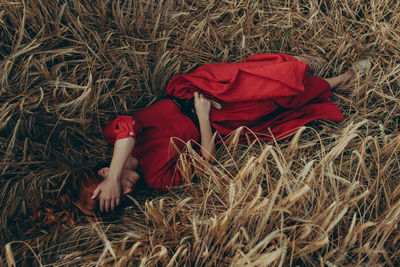 High angle view of woman lying on field