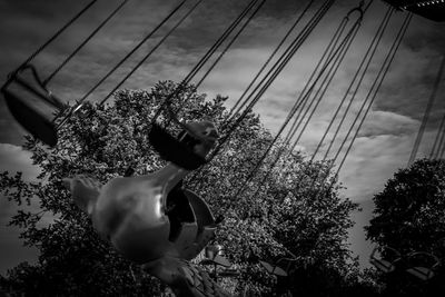 Low angle view of man on plant against sky