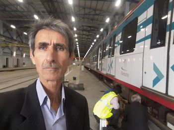 Portrait of man standing in bus