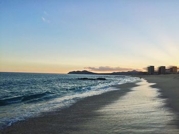 Scenic view of sea against clear sky during sunset