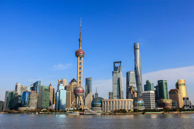 Low angle view of skyscrapers against blue sky