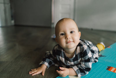 Cute baby girl playing with a toy on a play mat.