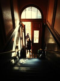 Full length of woman standing by railing