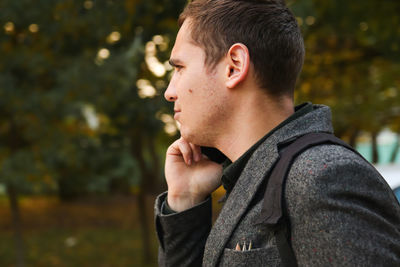 Side view of young man looking away