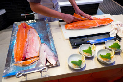 High angle view of man preparing fish on table