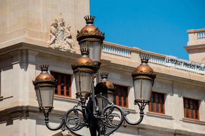 Low angle view of street light against building