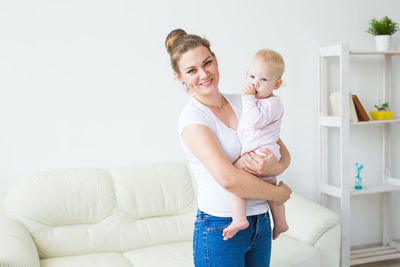 Mother and daughter baby on bed