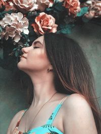 Close-up of woman smelling flowers