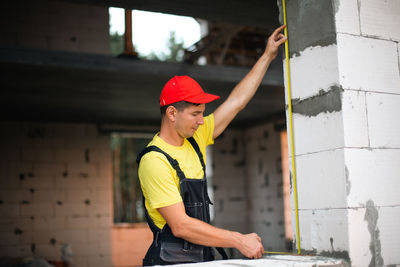 Side view of man working at construction site