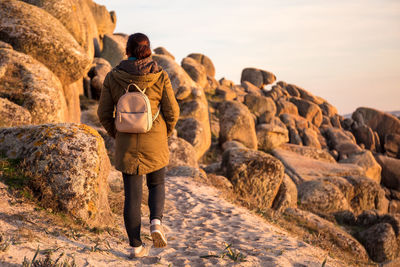 Woman walking on the coast at sunset. ribeira, spain