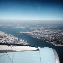 Aerial view of airplane wing against sky