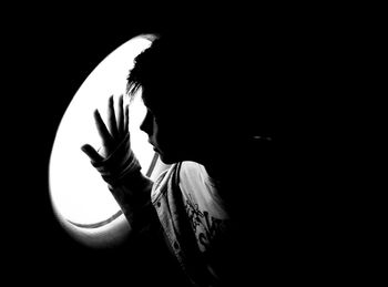 Silhouette of man against black background
