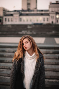 Portrait of a beautiful young woman standing in winter