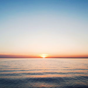 Scenic view of sea against clear sky during sunset