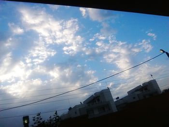 Low angle view of building against cloudy sky