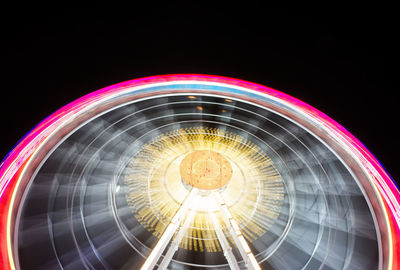 Low angle view of illuminated ferris wheel at night