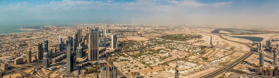 High angle view of modern buildings in city against sky