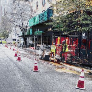 Empty road against buildings in city