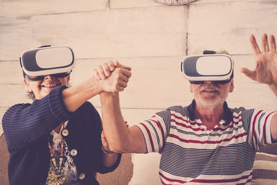 Senior couple using virtual reality simulator