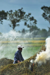 A farmer burns straw after harvesting rice in klumprit village, cilacap, central java, indonesia.
