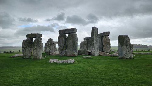 Rock formations on field against sky