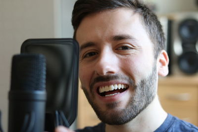 Close-up portrait of smiling young man
