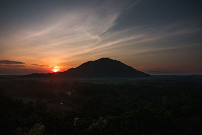 Scenic view of silhouette mountains against sky during sunset