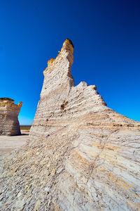 Low angle view of rock formations against sky